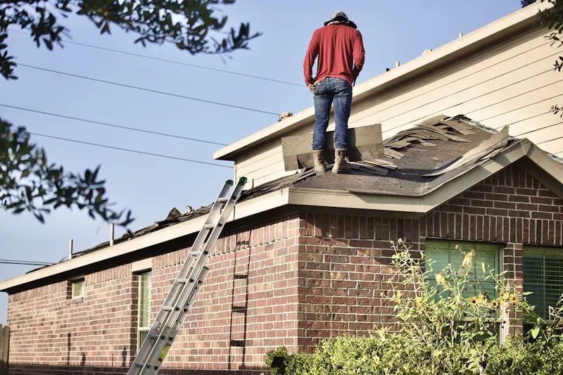 Professional roofer working on a residential roof in Russellville